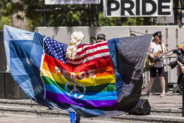 A peace flag is displayed on stage at the 2016 Central Oregon Pride in Drake Park. - CASABAY PHOTOGRAPHY