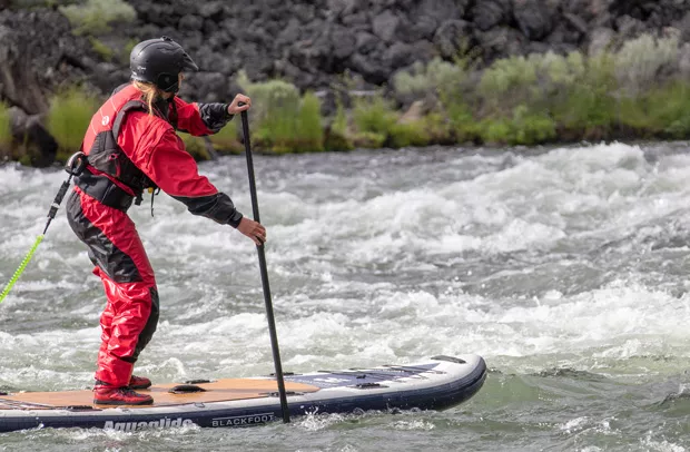 Black Foot Paddle boarding: Author KM Collins just before she clotheslines on a rock and takes a chunk out of her fin. - SUBMITTED