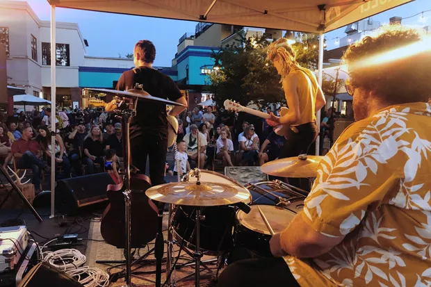 Jordan Wolfe, back to camera at left, performs earlier this year with Dive Bar Theology at The Commons. - SUBMITTED