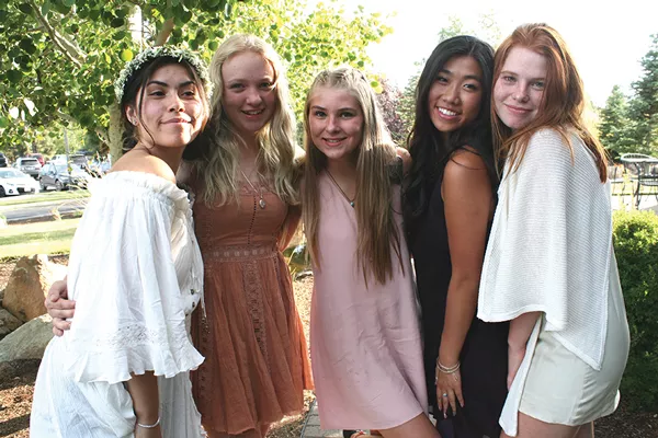 Sophia Rodriguez and some of her "damas" share a light moment outside her quinceañera party. - NICOLE VULCAN