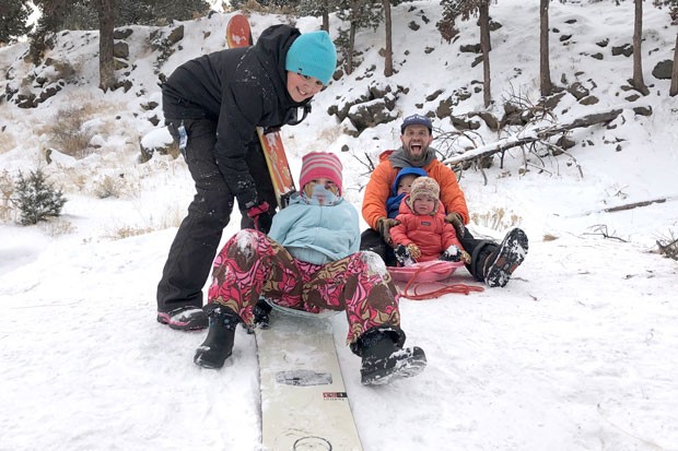 When the snow falls and you want to go sledding, sometimes you have to get creative! Bend kids Makoa and Maile Vidinha use a snowboard, sans bindings, to sled down the hills at Al Moody Park over the Thanksgiving weekend. At right, twins Gus and Eva Jones get their first sled ride from their dad, Matt Jones. - NICOLE VULCAN