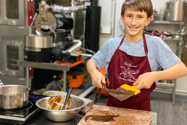 Reggie Strom tempers chocolate to make curls at Kindred Creative Kitchen. - LISA SIPE