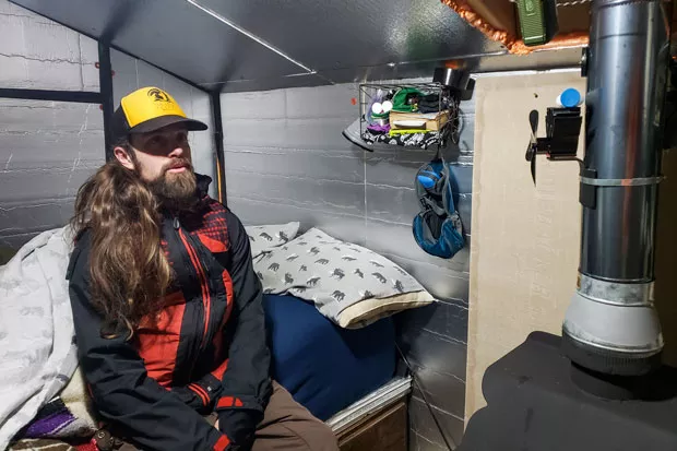 Thirteen blankets and a wood-burning stove help keep Mark Thompson warm when his cabin is covered in snow. - CAYLA CLARK