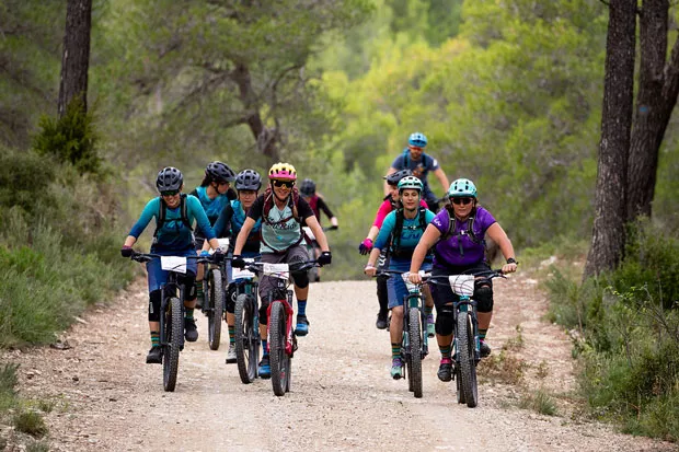 Members of Ladies All Ride joyfully bike through the Oregon woods. - JEFF CLARK