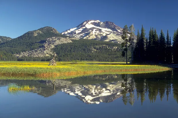 The South Sister reflected in the waters of Sparks Lake in the Three Sisters Wilderness Area. - USGS/CASCADES VOLCANO OBSERVATORY