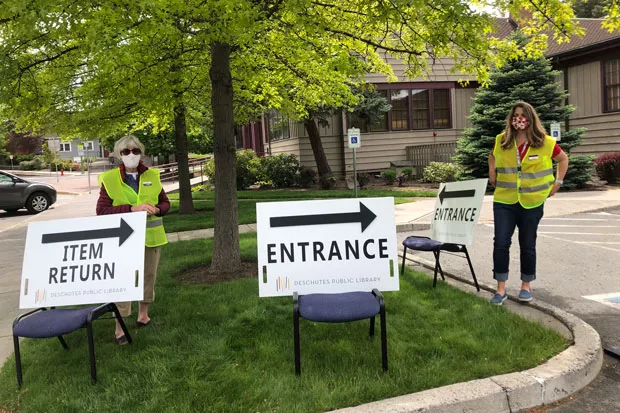 Things are starting to happen at the Deschutes Public Library! Staff set up an item return area Tuesday. Next week, library users can pick up existing holds. The following week, people will once again be able to pick up new holds—all curbside. - NICOLE VULCAN