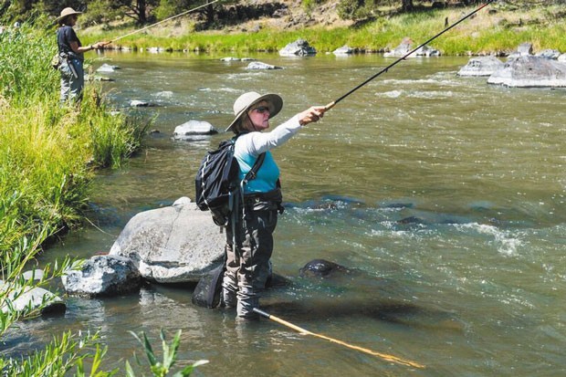 A member of Wild Women of the Water flex their fly fishing skills while enjoying the beautiful Central Oregon landscape. - COURTESY WILD WOMEN OF THE WATER