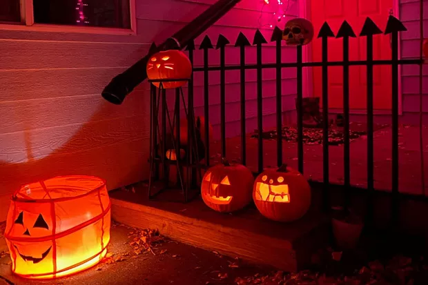 Headstones crafted from cardboard invite the neighborhood kids to go through on Halloween night—if they dare. - MIKE MANSER