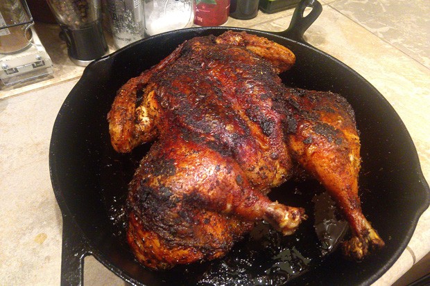 A dry-brined, ancho-chile-rubbed chicken roasted for about an hour and ready to carve. - ASHLEY MORENO
