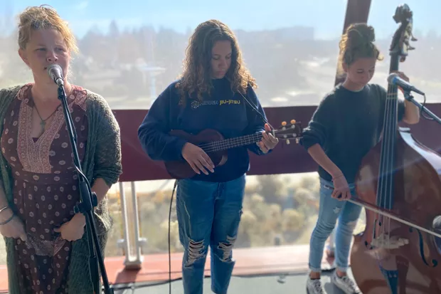 Melodi Johnson, at left, with twins Shiloh Johnson and Abigail Johnson, at their first "official" show during Bend Roots Revival in October. - NICOLE VULCAN