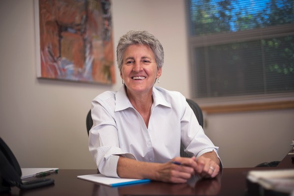 Dr. Becky Johnson sits at her desk for a photo taken for Oregon State University’s College of Business Magazine. - COURTESY OF OREGON STATE UNIVERSITY — CASCADES