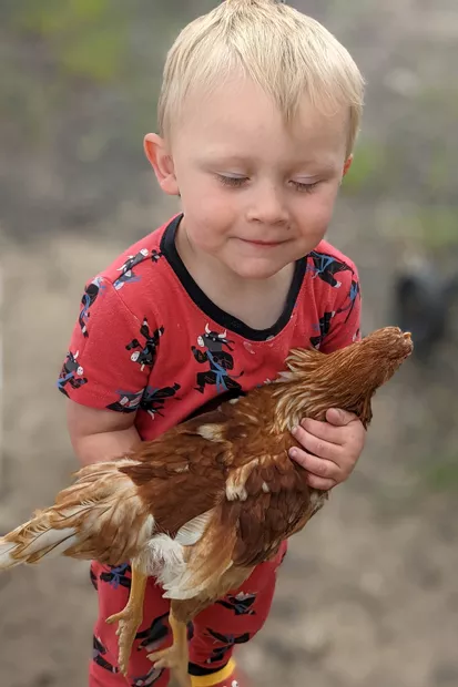 A family member of Susan Sapp holds Tiny, the red hen. - SUBMITTED