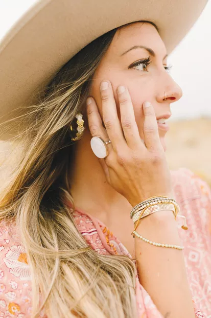 Bronwen Cuddled Hearts Earrings by WorldScout, $98 Moonstone Ring by WorldScout, $98 Solstice Bracelet by Bronwen, $39 Peeky Bracelet by WorldScout, $39 / Dutch + Bow ‘Colorado Winter’ Handmade Wool Hat by Hampui Hats, $375 - DREW CECCHINI