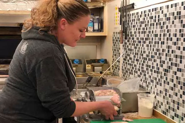 Amos cooks up tacos inside Westside Taco Co. in 2108. - CREDIT LISA SIPE