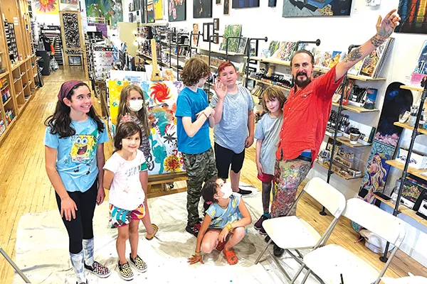 Students in the program, above and below, get to work on their art and get personal feedback from artist Nicola Carpinelli. - HILLARY CHRISTEN