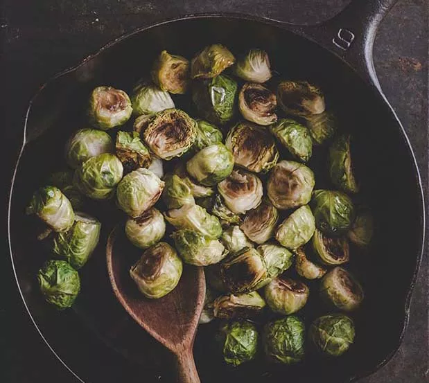 A cast iron skillet is perfect for cooking Brussels sprouts on the stovetop but can also be used for roasting sprouts in the oven. - TAMBI LANE PHOTO