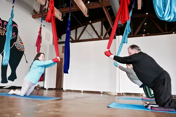 AIReal instructor Mandy Butera, left, leads Source staffers Magdalena Bokowa and Richard Sitts through the motions. - NICOLE VULCAN