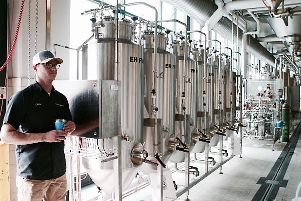 Deschutes Assistant Brewmaster Chris Dent shows off the brewer's R&D testing tanks. - KEVIN GIFFORD