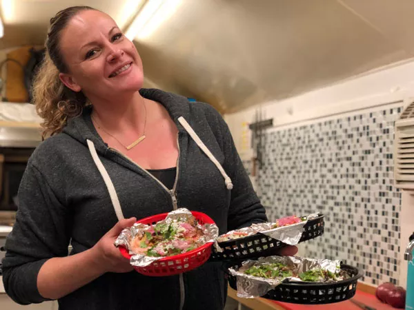 Chef Amber Amos makes each corn tortilla by pressing masa, a corn flour dough, through a hand-cranked tortilla press, shown below, with delicious results. - LISA SIPE