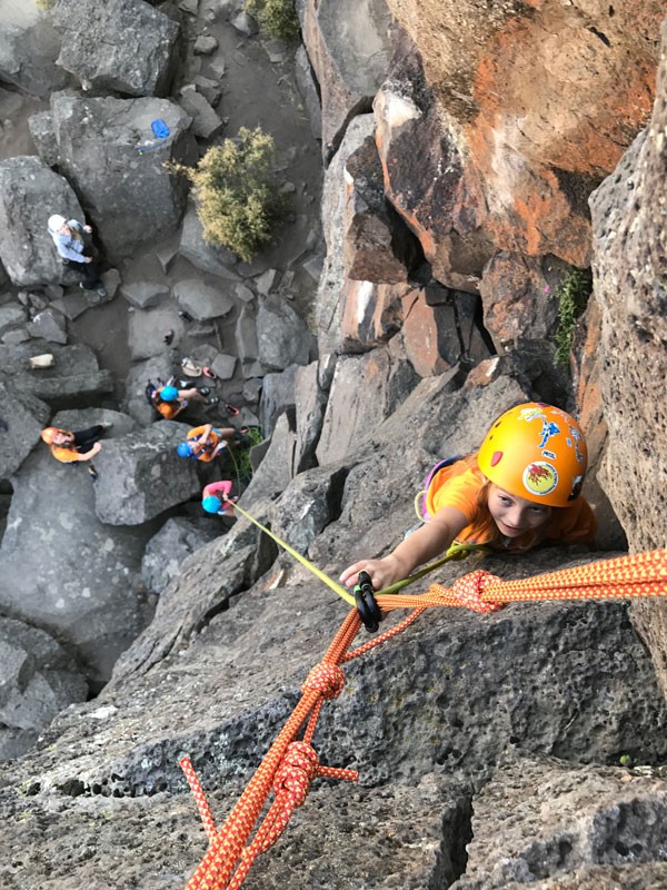 Young girls rope in their confidence on a sheer rock face. - BEND ROCK GYM