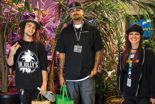 Pritesh Patel the 2018 winner of the budtender contest. Second place went to Hunter Chalker, left, and third place went to Molly Kelly, right. - KEELY DAMARA