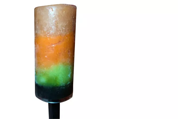 The salad course was a palate cleanser: a layered popsicle of Greek salad, carrot and celery sorbet. - LISA SIPE