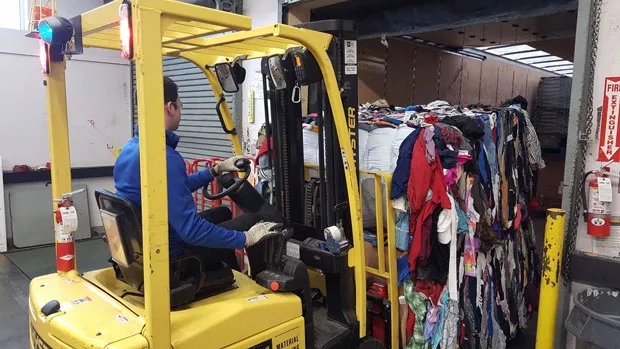 Unsold clothing donations at Bend Goodwill are bundled into bales for salvage. - GOODWILL INDUSTRIES