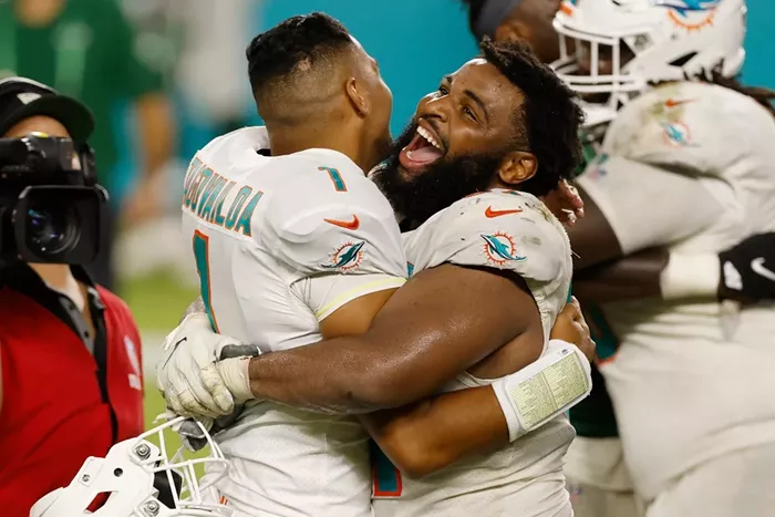 Christian Wilkins celebrates with Tua Tagovailoa after he made his NFL debut against the New York Jets. - PHOTO BY MICHAEL REAVES/GETTY