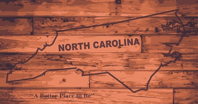 North Carolina map on wood with "A Better Place To Be" motto