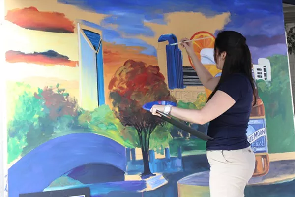 A painter creates the Charlotte skyline
