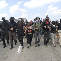 Anarchists and anti-capitalists march in St. Paul near the state capital chanting, \&quot;Fight the Rich Not Their Wars!\&quot; on the first day of the Republican National Convention. This group was one of seven around the city that set out to do \&quot;direct actions\&quot; separate from the main permitted march.