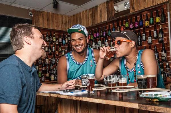 Brody and Choch, with Hahne (far left), trying some of the beers at Ass Clown Brewing. - JUSTIN DRISCOLL