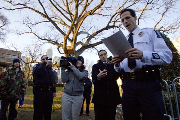Capt. Estes of the CMPD reads the new city ordinance to members of Occupy Charlotte