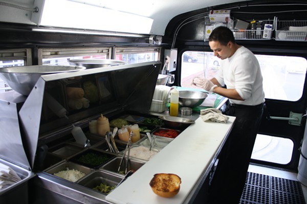 Chef Aaron creates American street sandwiches in his chrome gray school bus turned food truck.