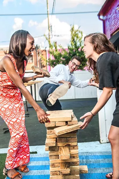 CL interns Brittaney Major, Sean Billings and Deborah Swearingen hone their architectural skills on Jumbo Jenga at Blind Pig. - JUSTIN DRISCOLL