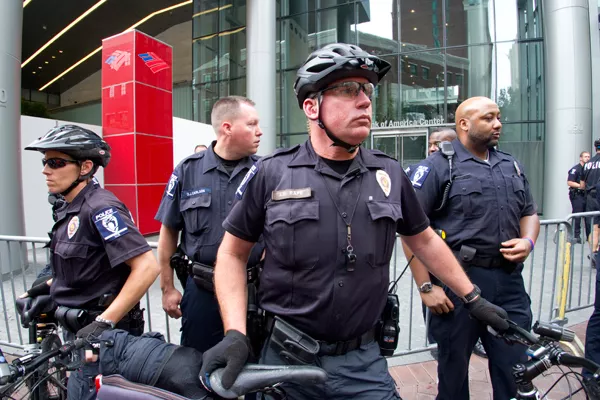 CMPD Officers standing guard in front of the Bank Of America shareholders meeting entrance. (Photo by Grant Baldwin)