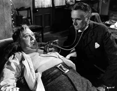 DOCTOR DOOM: Dr. MacFarlane (John Laurie) prepares to give Henry Hobson (Charles Laughton) the bad news in Hobson's Choice.