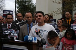 PATRICIA ORTIZ QPMG - Gabino Sanchez and his family at a March rally outside the Charlotte Immigration Court building, with Illinois Democratic Congressman Luis Gutierrez to his left.