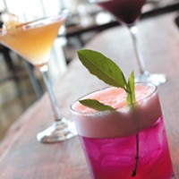 Halcyon signature cocktails include the Pink Heelsplitter (front); Queen 2 Bee (back left); and Pickled Up in Blue (back right)