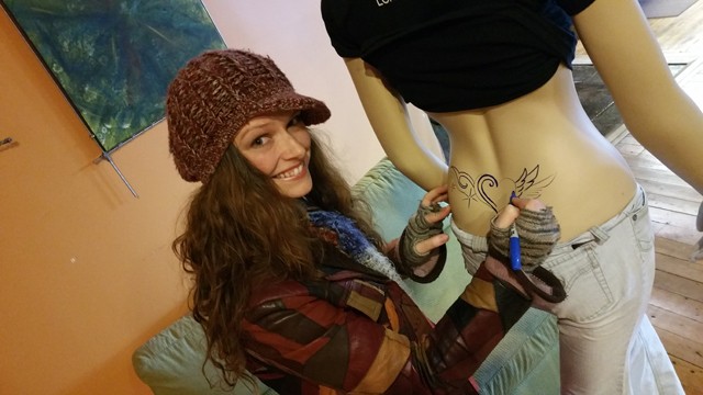 Hayley Moran tags one of the office mannequins with her art.