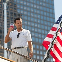HERE'S TO THE AMERICAN DREAM: Jordan Belfort (Leonardo DiCaprio) salutes his own success in The Wolf of Wall Street. (Photo: Paramount)