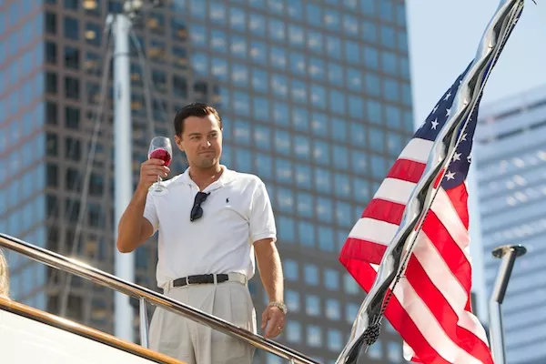 HERE'S TO THE AMERICAN DREAM: Jordan Belfort (Leonardo DiCaprio) salutes his own success in The Wolf of Wall Street. (Photo: Paramount)
