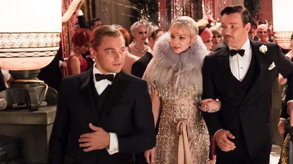 LIFESTYLES OF THE RICH AND FAMOUS: Jay Gatsby (Leonardo DiCaprio, left) provides Daisy (Carey Mulligan) and Tom (Joel Edgerton) with a tour in The Great Gatsby. (Photo: Warner Bros.)