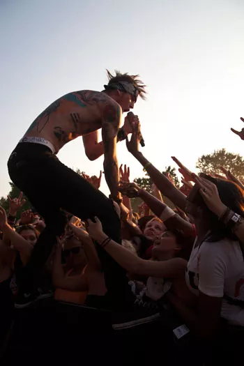Machine Gun Kelly jumped onto the barricade to get closer to fans at the Vans Warped Tour stop in Charlotte on July 30, 2012, at Verizon Wireless Amphitheatre.