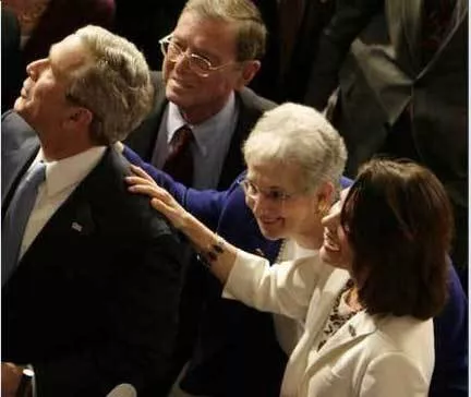 Michele Bachmann (right) and fellow incoherent Dubya worshipper Rep. Virginia Foxx, touch the garment of their Annointed One