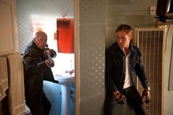 RICHARD FOREMAN / FILM DISTRICT - MOTOR INSTINCTS: Driver (Ryan Gosling, right) protects himself against a hitman in Drive.