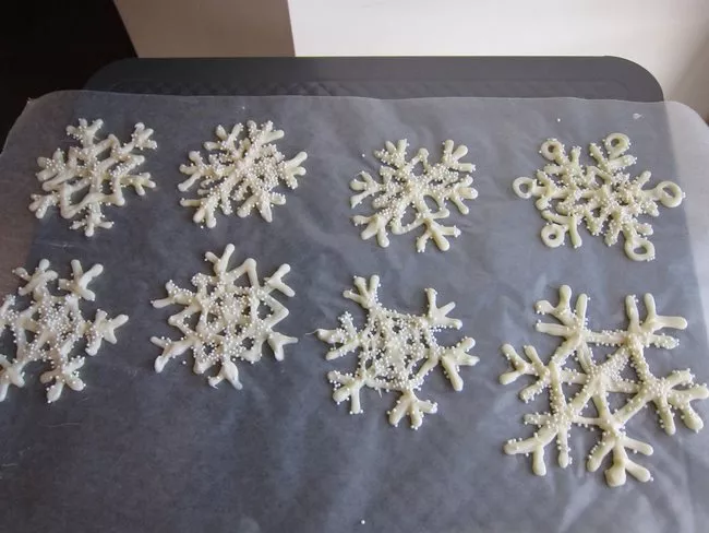 My tray of piped snowflakes, sprinkled with non pareils.