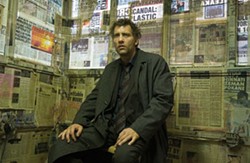 NEWS OF THE DAY Theo (Clive Owen) follows the paper trail in Children of Men. - JAAP BUITENDIJK / UNIVERSAL