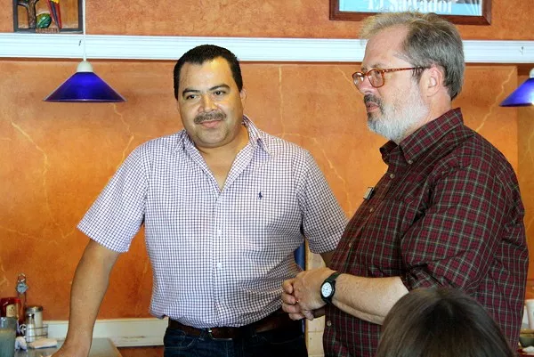 Owner Henry Chirinos talks to the tour group with Dr. Tom Hanchett