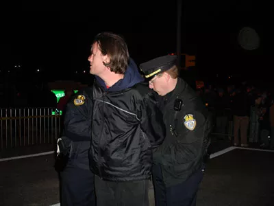 Scott Langley being arrested at the protest of the execution of Perrie Dyon Simpson